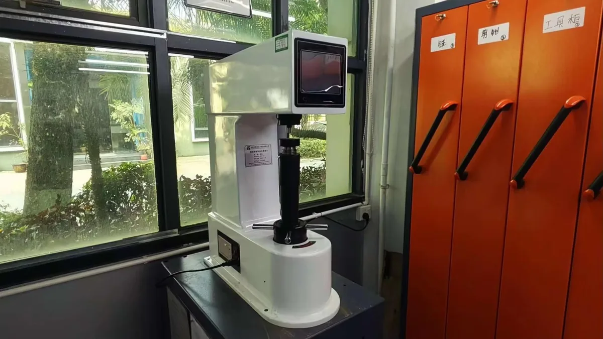 Benchtop hardness tester in a materials testing laboratory between storage cabinets