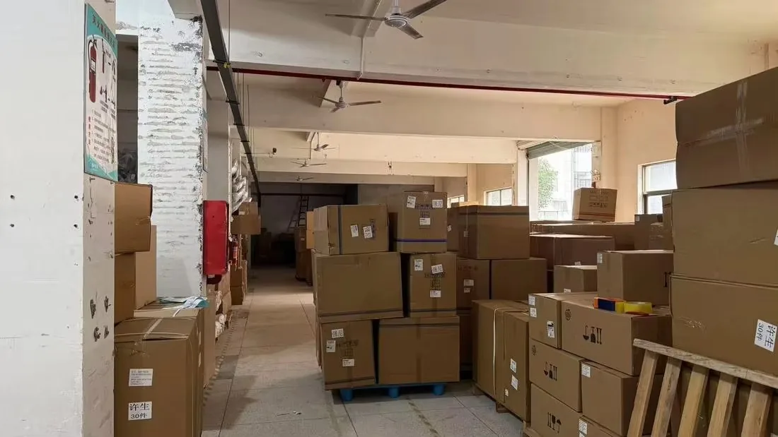 Cartons stacked along the aisle of a storage building awaiting consolidation